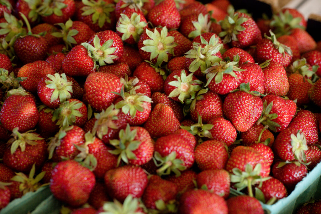 Container of fresh strawberries for jam