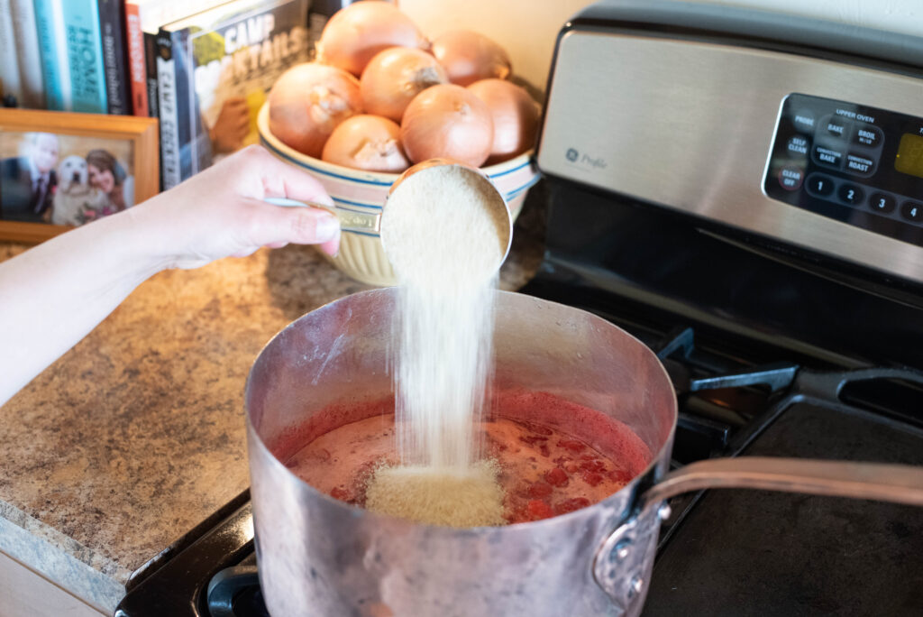 Sugar being added to strawberry jam