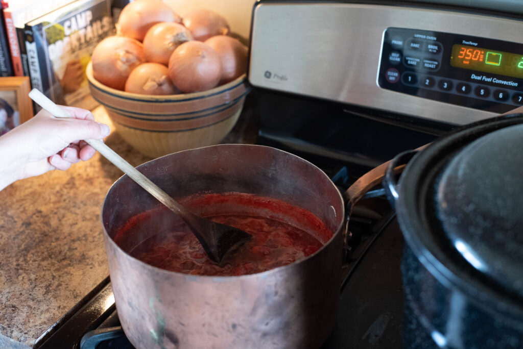 Strawberry jam simmering and being stirred