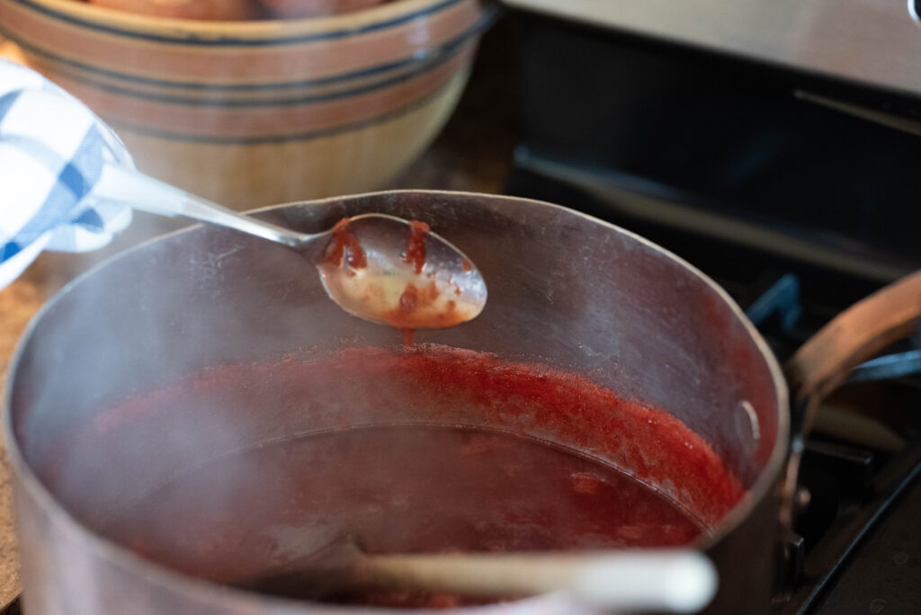 A frozen spoon testing the readiness of strawberry jam