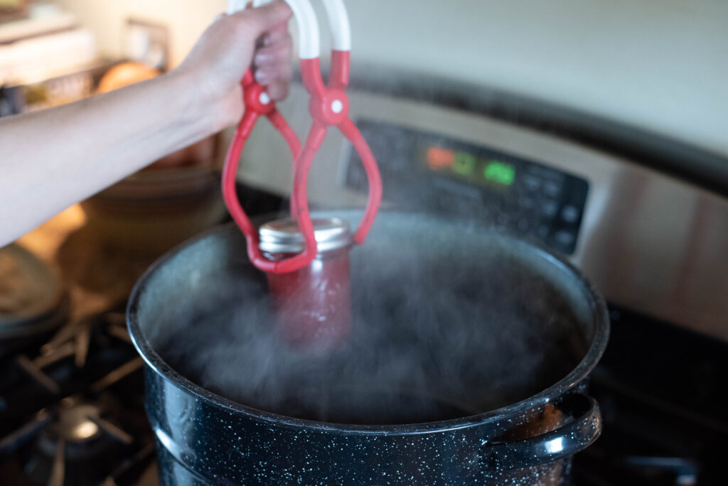 A jar of jam ready for water bath canning
