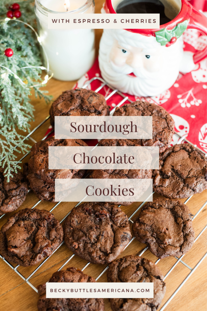 chocolate sourdough cookies on a wire rack with Santa mug and wreath