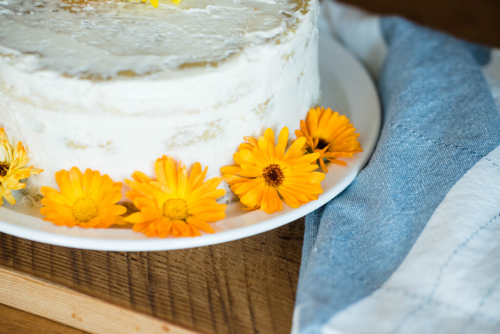 new gardener's guide featuring how fresh calendula leaves can decorate a vanilla cake