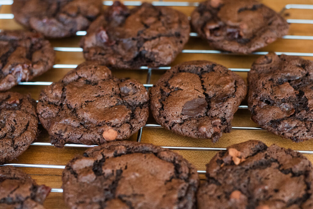 chocolate sourdough cookies cooling on wire rack