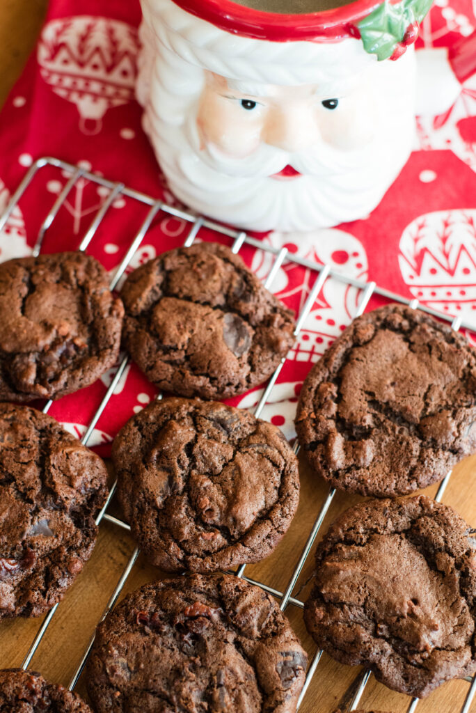 chocolate sourdough cookies on wire rack with Santa mug
