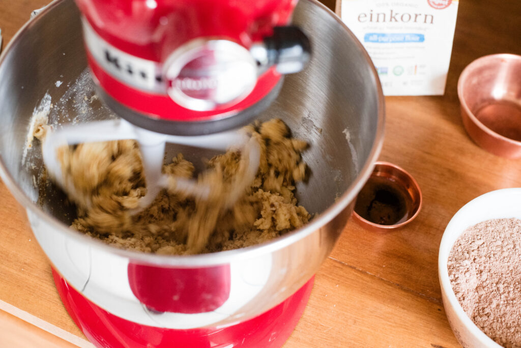 butter and sugar being creamed together in mixing bowl
