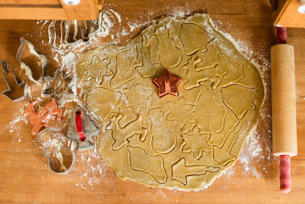 Cookie dough cut into shapes with cookie cutters 