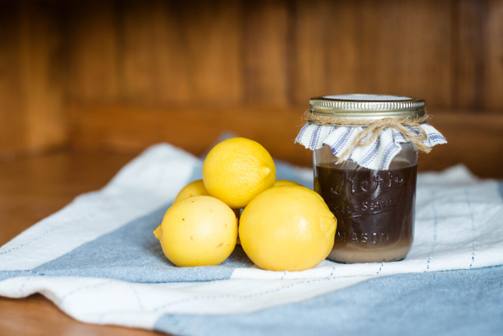 Jar of homemade lemon pectin with whole lemons
