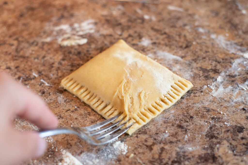 Fork crimping hand pie dough