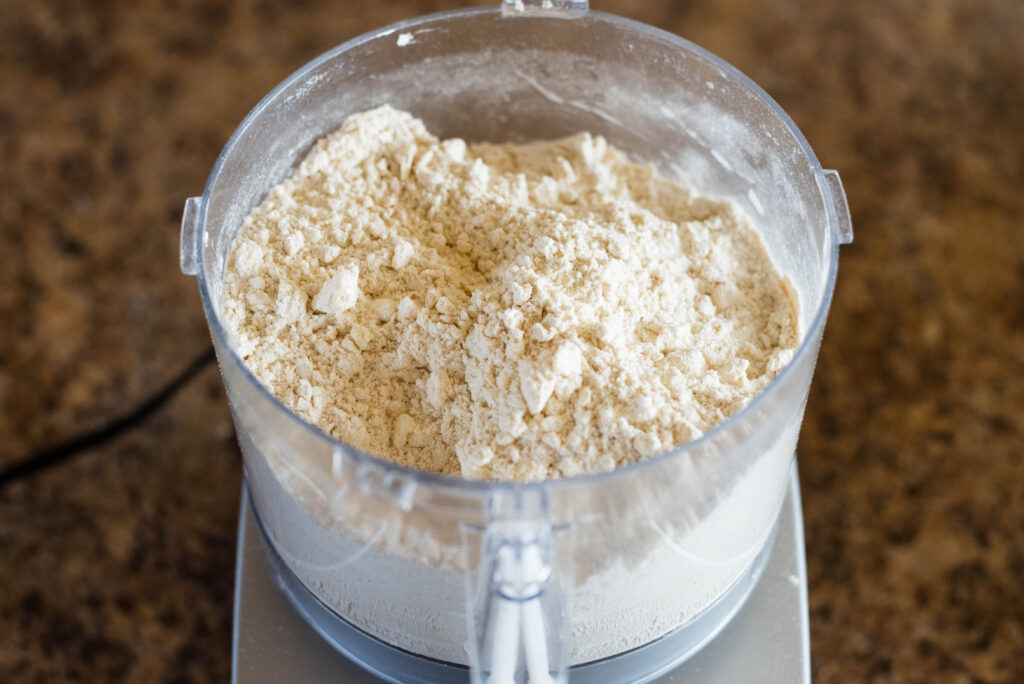 Course crumbly texture of butter cut into flour mixture