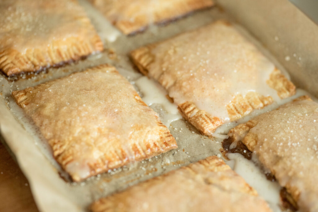 Easy from-scratch pumpkin hand pies cooling on cookie sheet