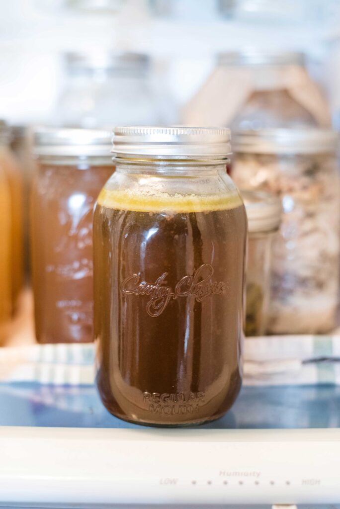 Jar of bone broth chilled in the refrigerator 