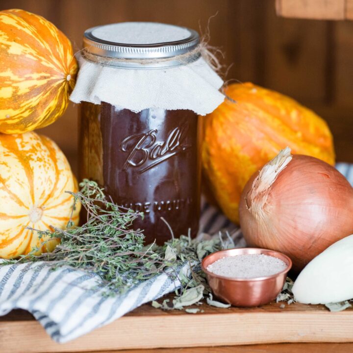 Jar of broth with squash, onions and bowl of salt