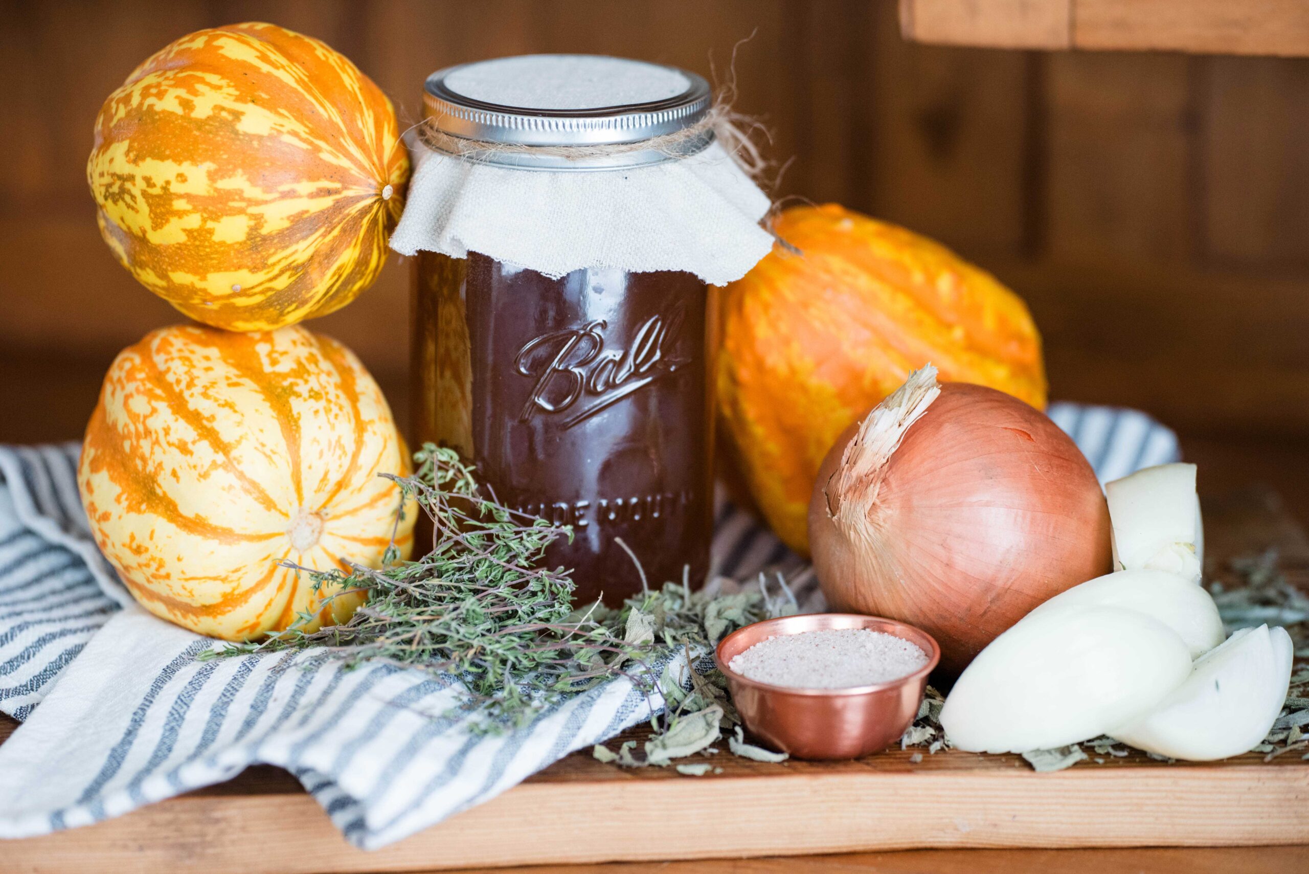 Jar of broth with squash, onions and bowl of salt