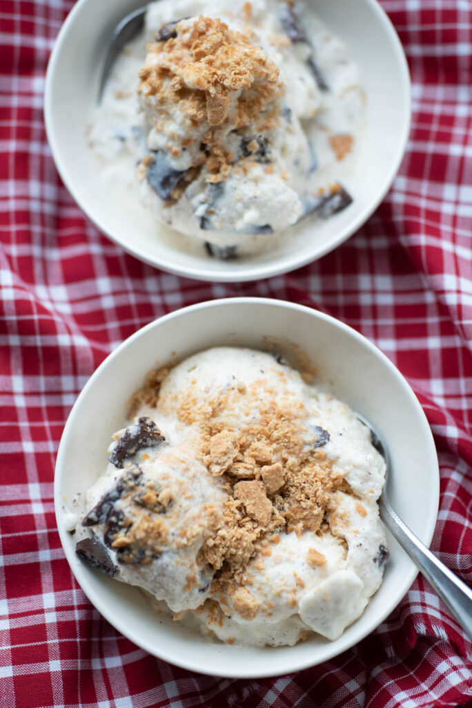 Bowls of hand-churned ice cream with chocolate and graham cracker crumbles.