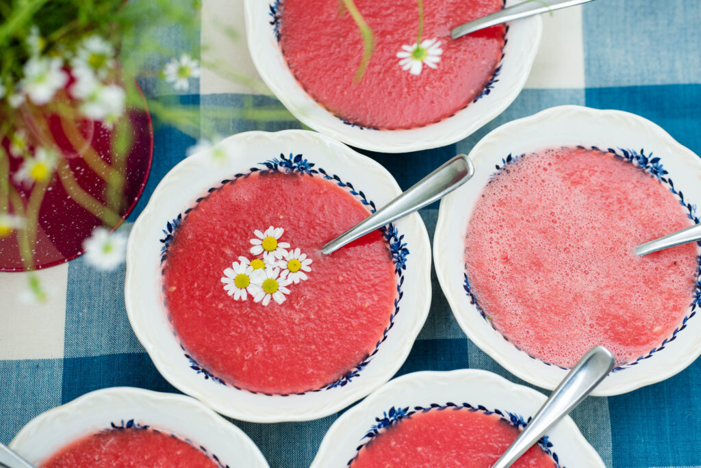 Bowls of watermelon soup with chamomile flowers