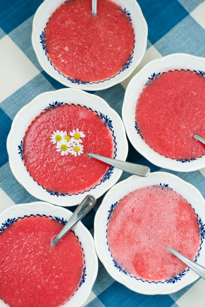 Bowls of watermelon soup on a checkered tablecloth