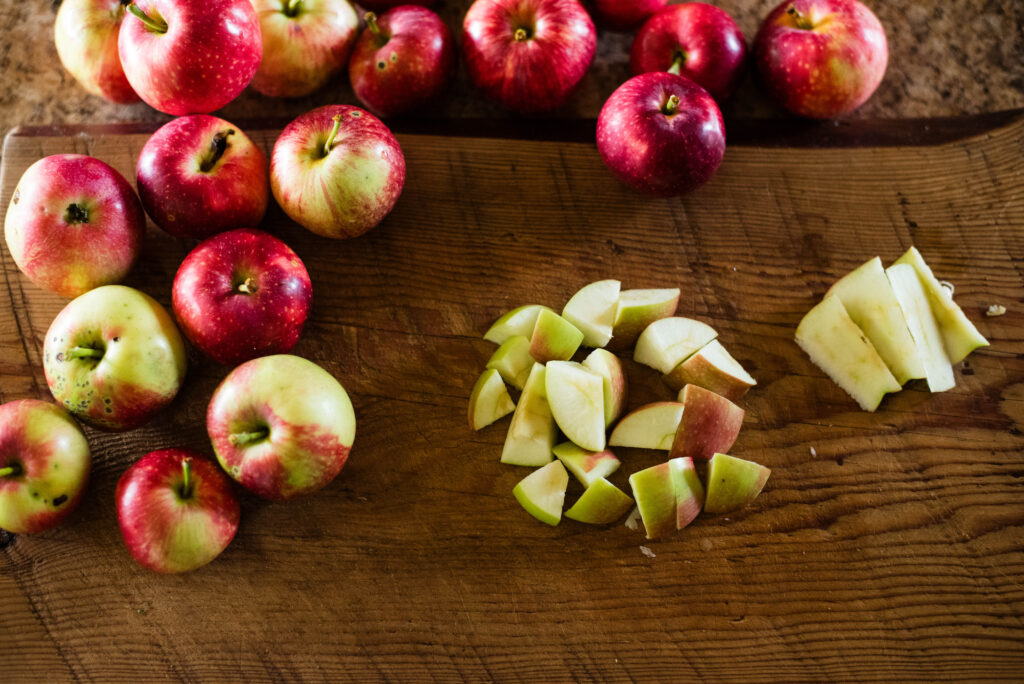 Apple scraps on a cutting board.