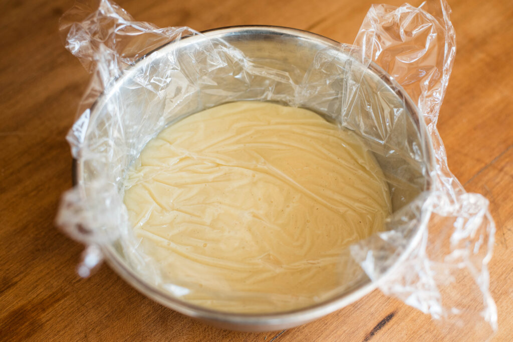 Ganache resting and covered tightly with plastic wrap