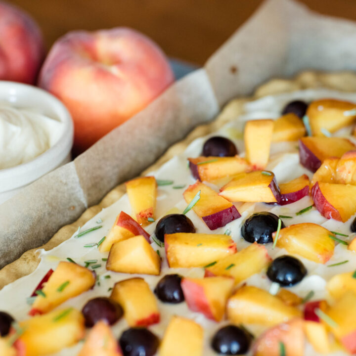 Fruit pizza with peaches and grapes