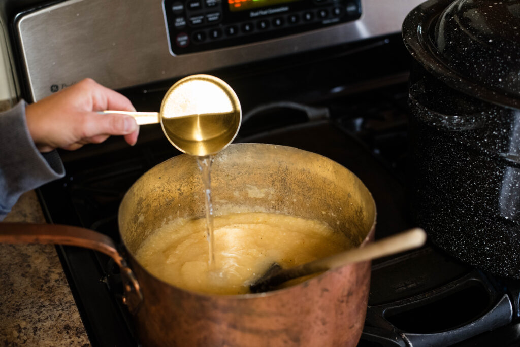 Water being added to pureed applesauce.