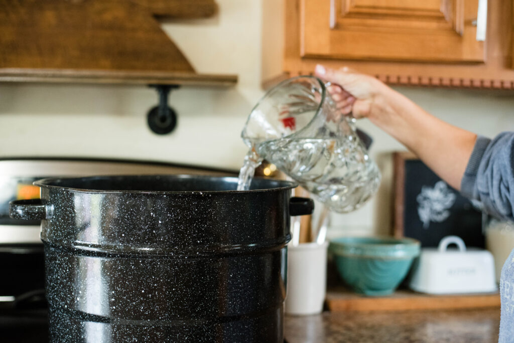 Water being poured into water bath canner.