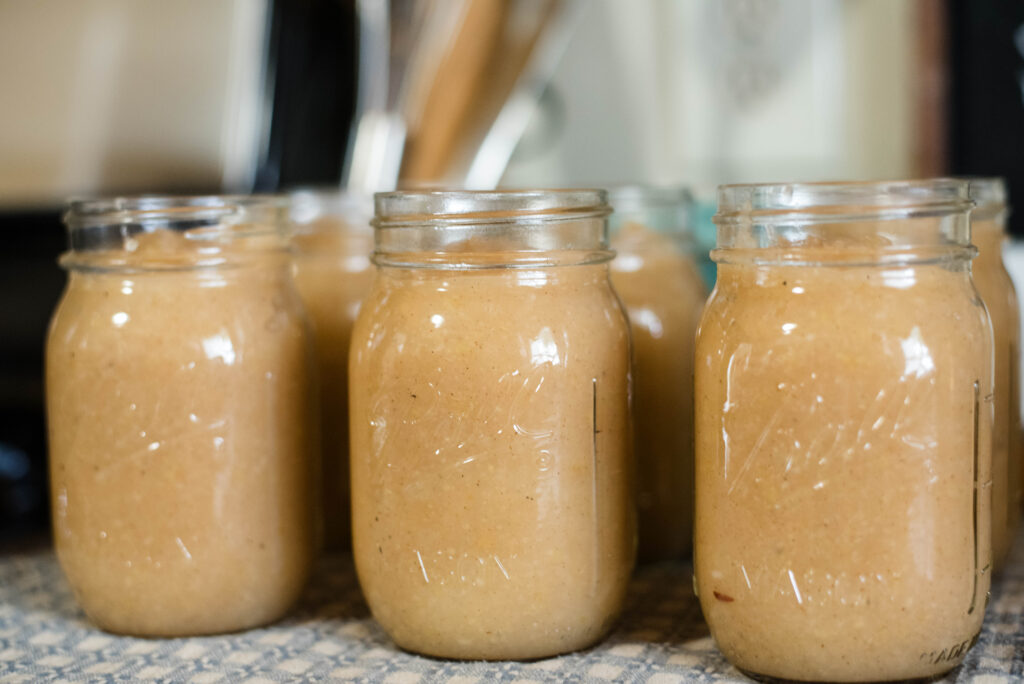 Jars of applesauce waiting for canning.