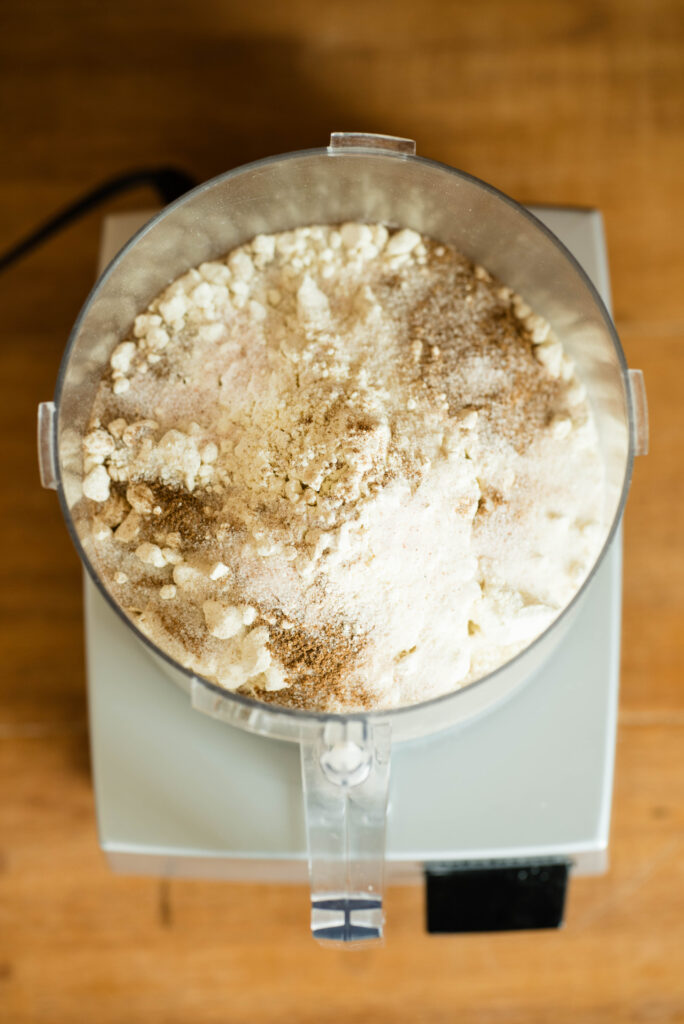 Dry ingredients for homemade hand pies in a food processor.