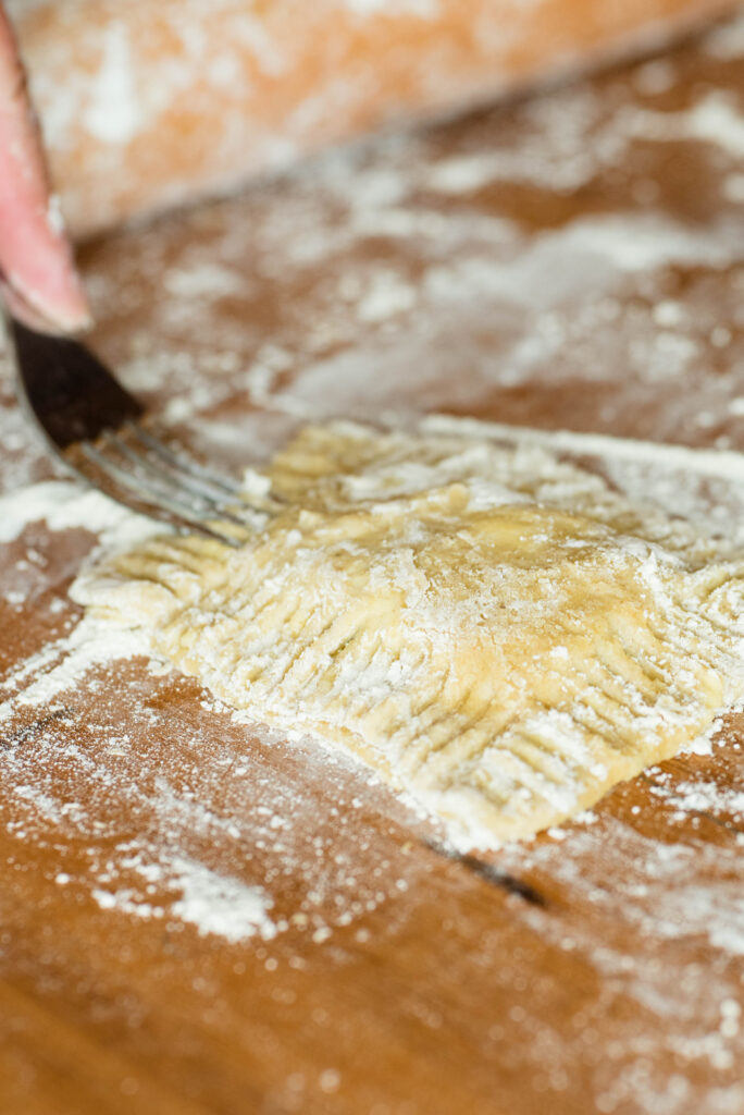 Fork crimping edges of hand pie.