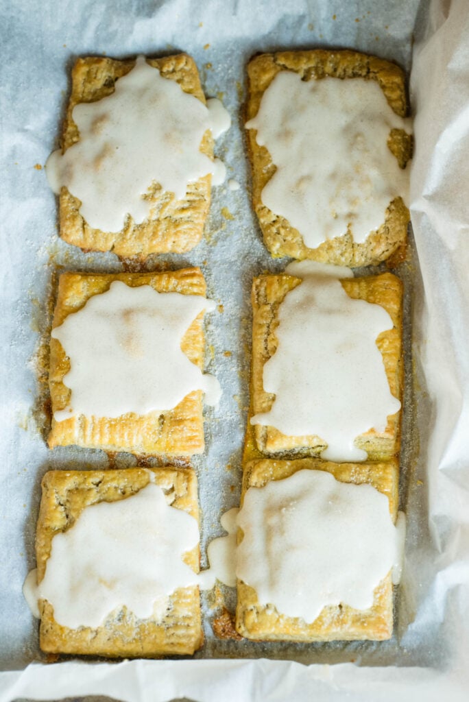 Tray of iced homemade pumpkin hand pies.