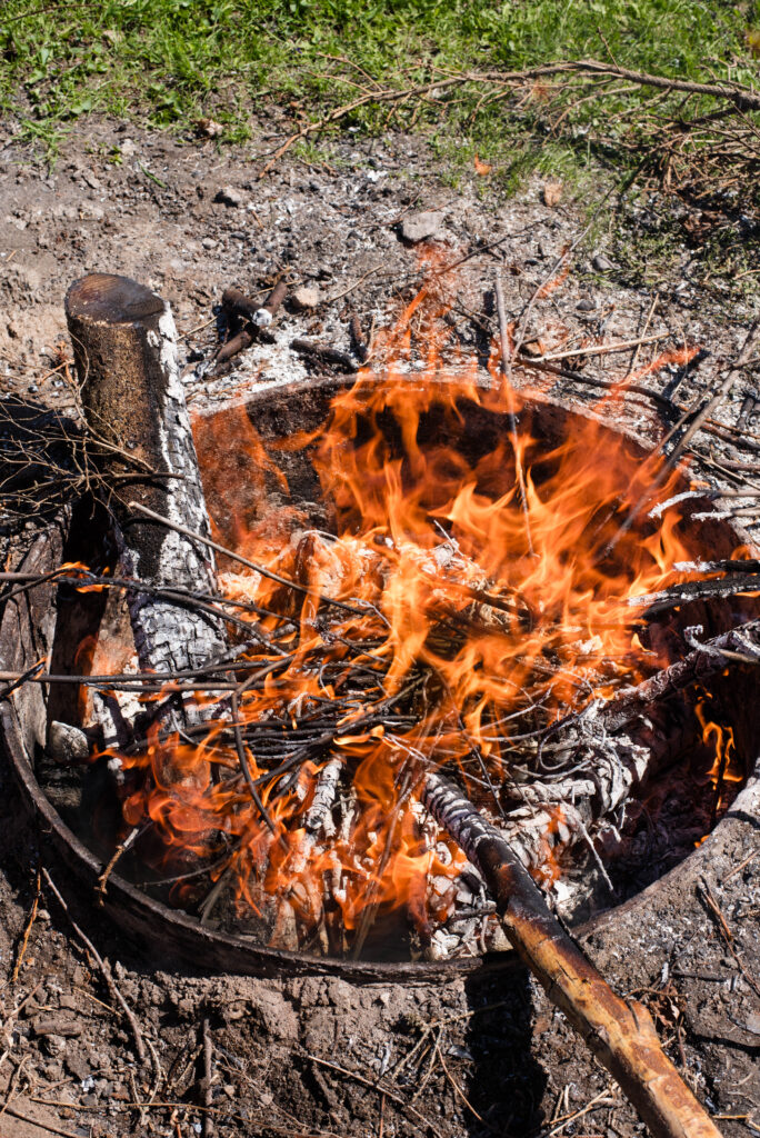 A fire burning wood for biochar