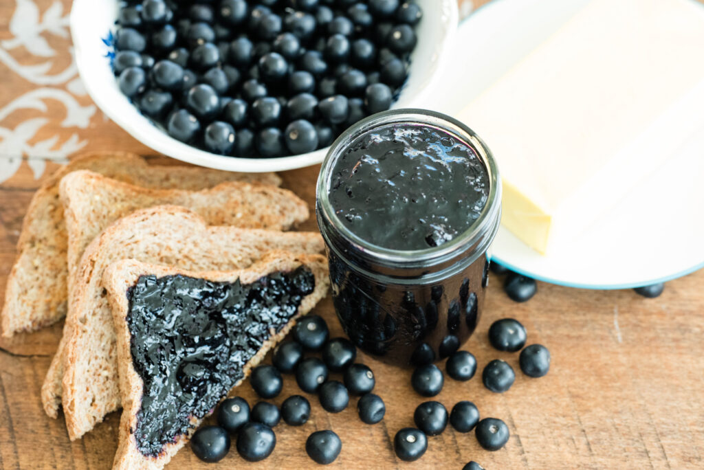 Huckleberry jam with toast, butter and fresh huckleberries