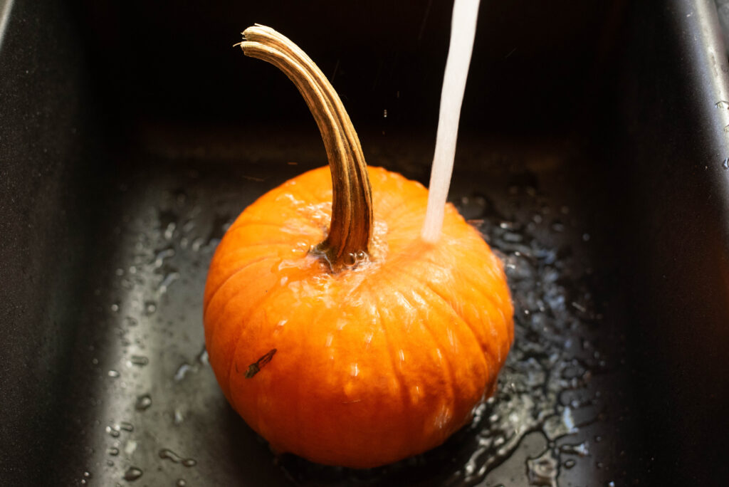 A pumpkin being washed.