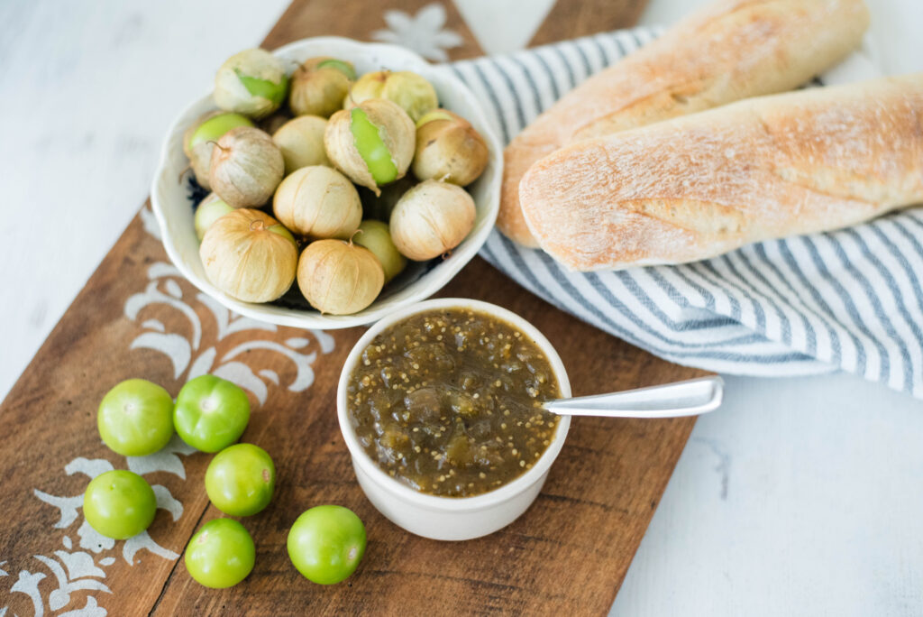Tomatillo jam pictured with fresh tomatillos and bread