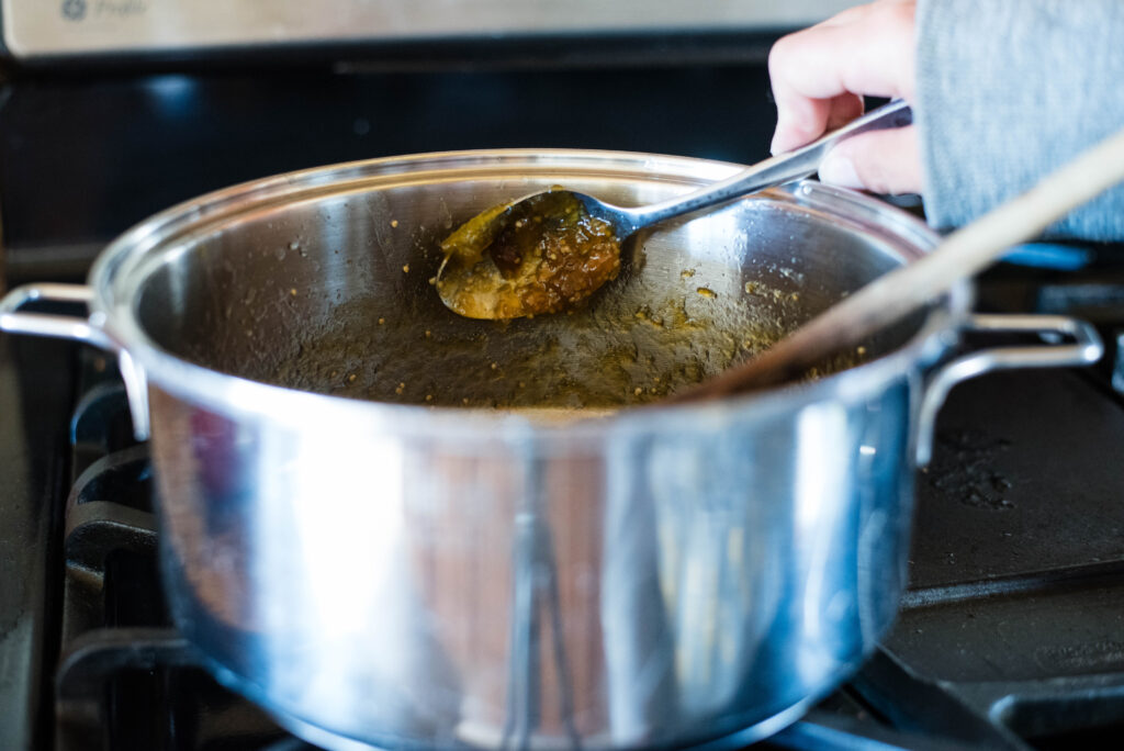 Tomatillo jam sticking to the back of a frozen spoon.