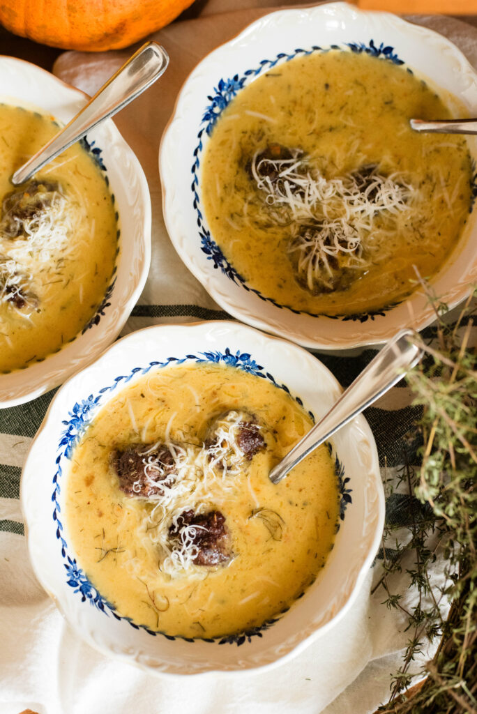 bowls of pumpkin sausage soup with fresh thyme
