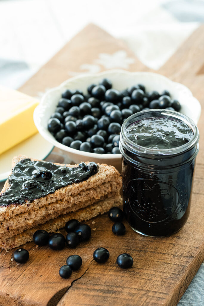 Huckleberry jam, butter, toast and fresh huckleberries.