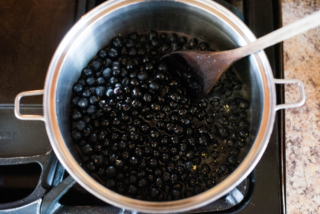 Huckleberry jam ingredients in a saucepan.