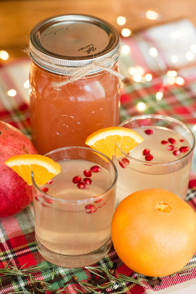 Old-fashioned Christmas cocktail shrub with oranges, pomegranates, rosemary and cloves