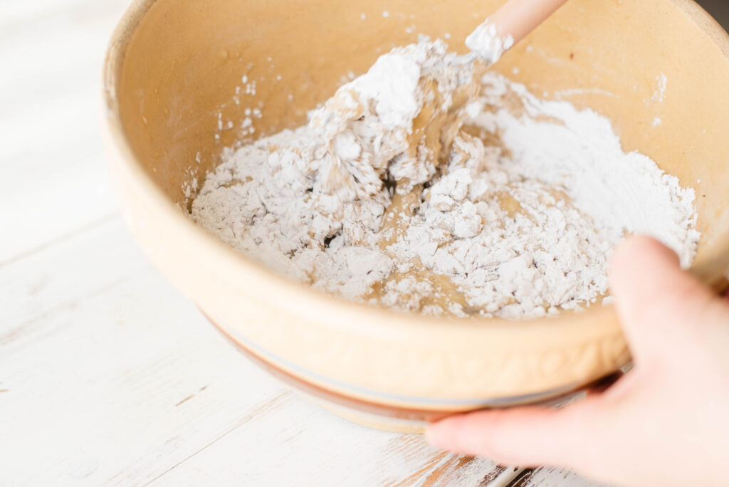 Dry ingredients added to wet ingredients for banana bread