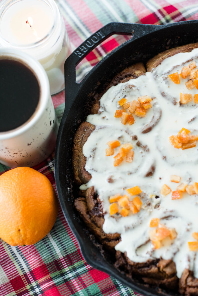 sourdough gingerbread cinnamon rolls in a cast iron skillet