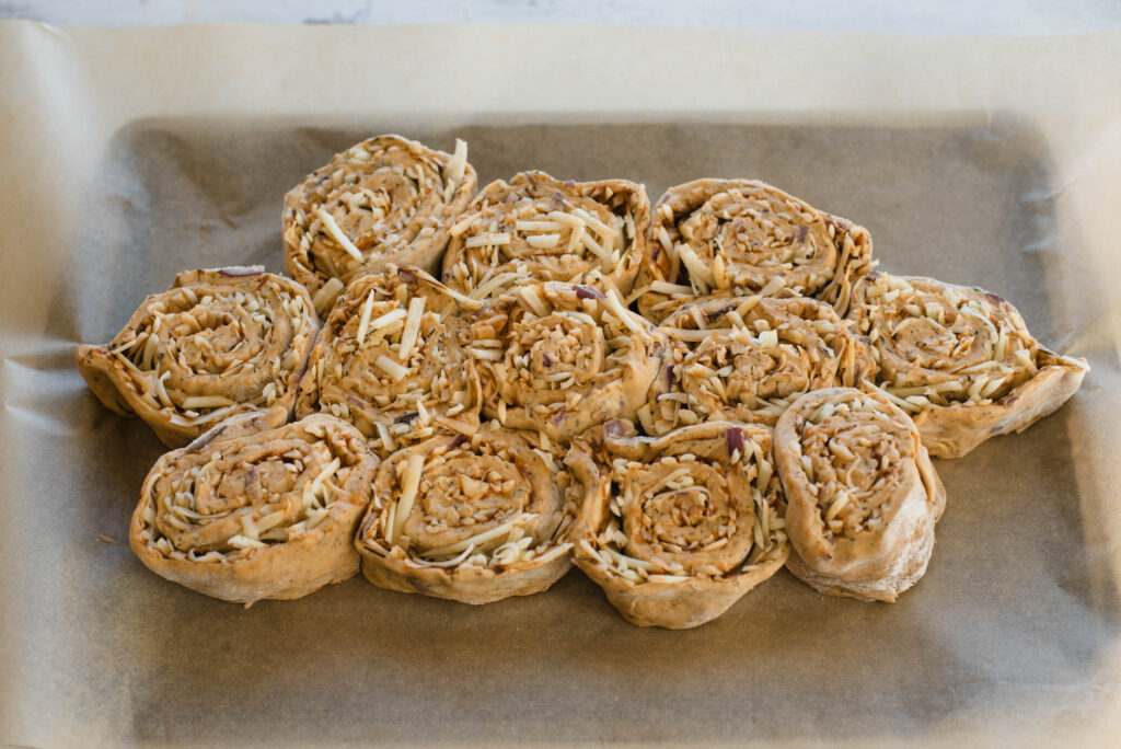 pizza rolls arranged into a football shape before baking