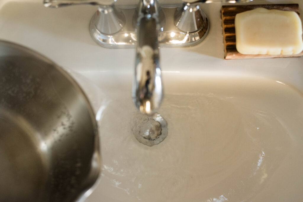 Hot water poured down a clogged drain