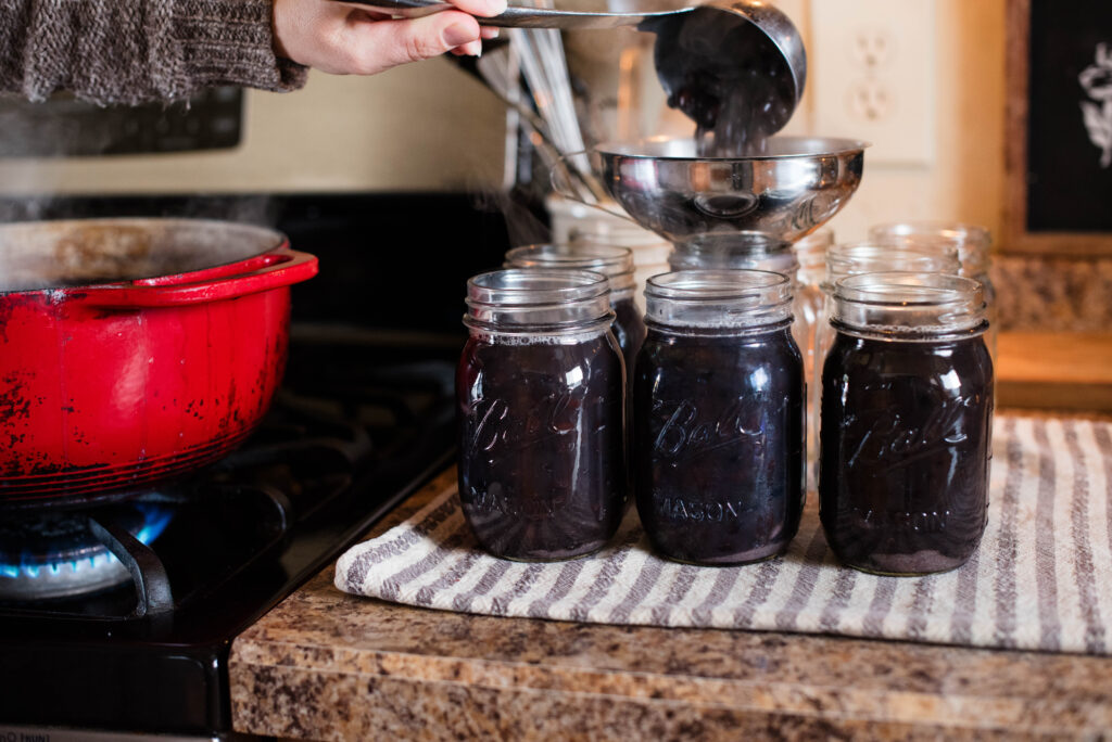 Beans ladled into jars for pressure canning