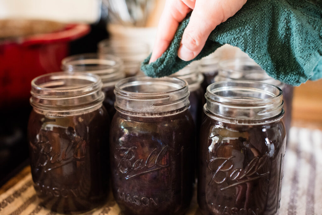 Rims wiped clean before pressure canning.
