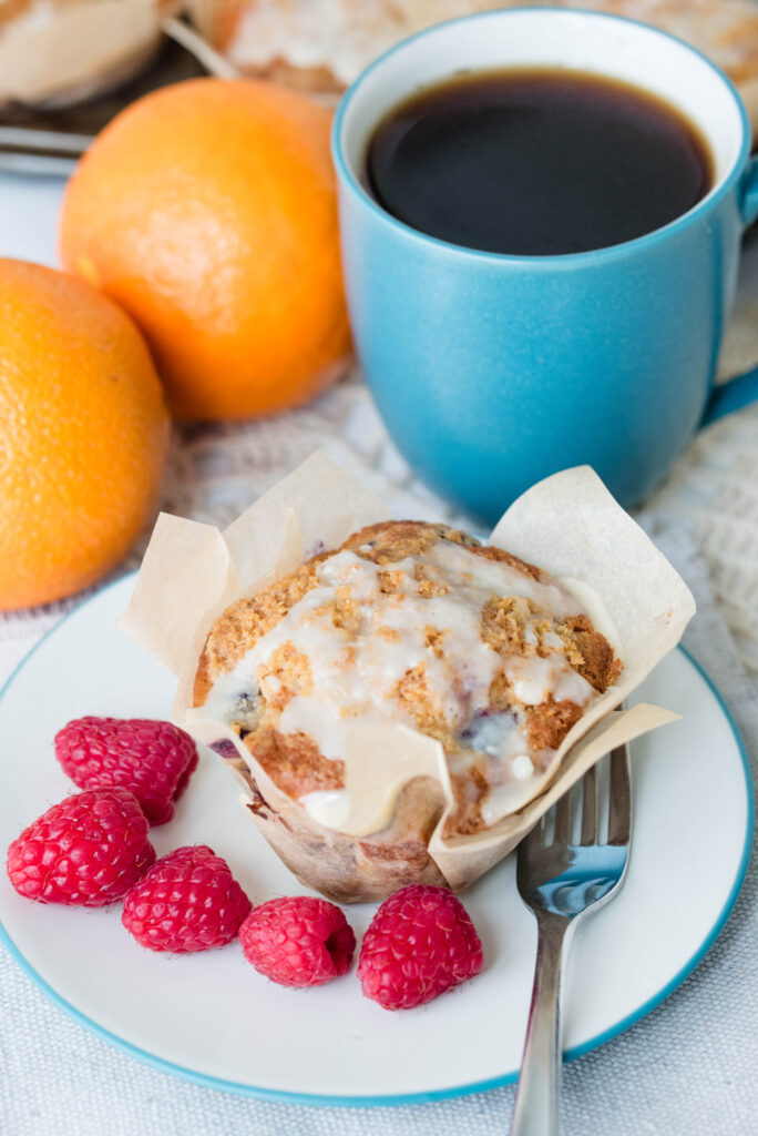 bakery style berry orange muffins with coffee