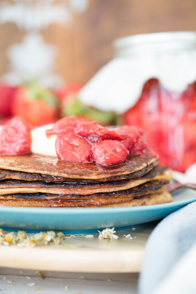 fermented strawberries with honey on top of fresh pancakes for breakfast