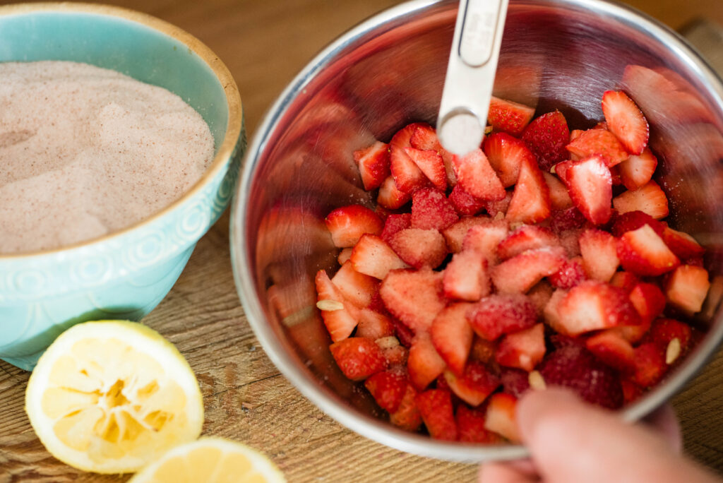 Salt being added to fermented strawberries with honey