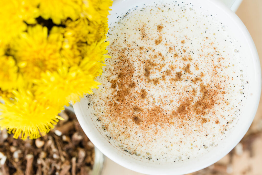 Dandelion root tea latte with fresh jar of dandelions and root
