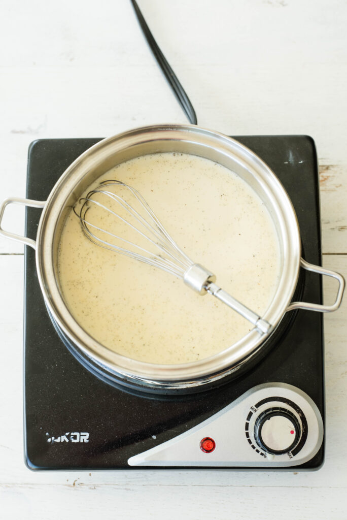 Milk and ingredients warming for dandelion root tea latte